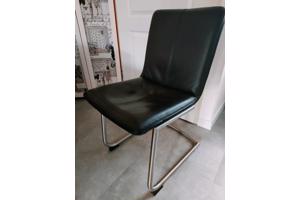 Vier zwart lederen eetkamerstoelen