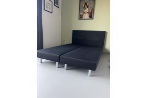 Zwart bed met achterplaat van stof
