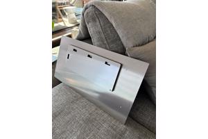 Two black and white photographs printed on metal