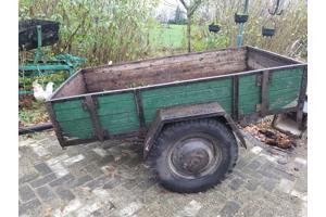 Oude boeren aanhanger met bladveren voorzien van dikke bande