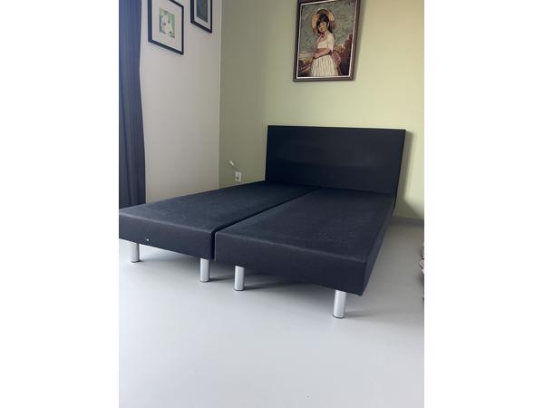 Zwart bed met achterplaat van stof