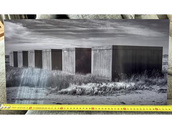 Two black and white photographs printed on metal