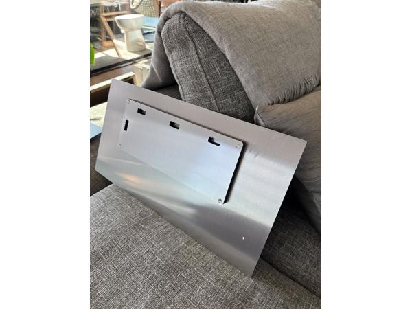 Two black and white photographs printed on metal