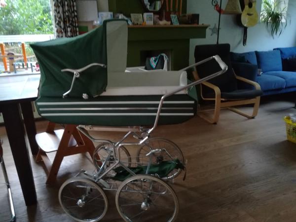 Ouderwetse groene kinderwagen