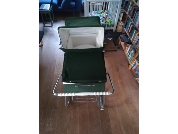 Ouderwetse groene kinderwagen